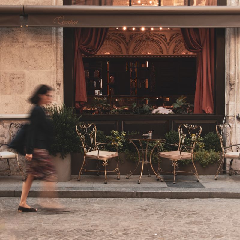 Fachada de un café con encanto y mesas en la terraza